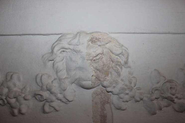 Mascherone in stucco tra ghirlande, in una sala del secondo piano nobile